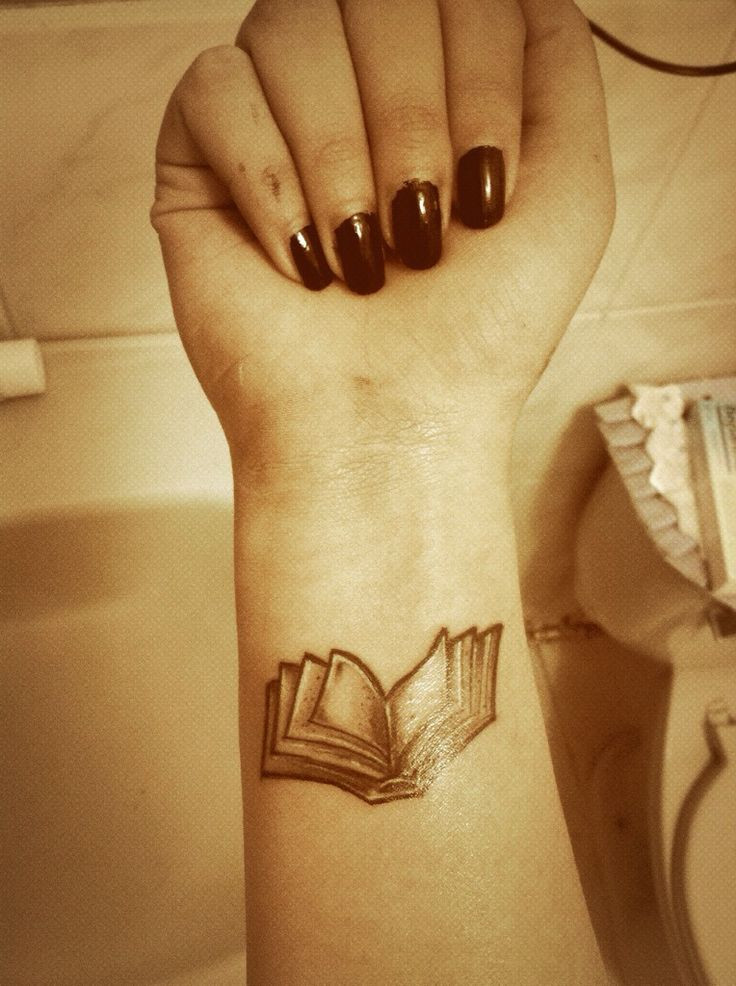 Book tattoo on the inner arm