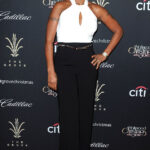 Mary J Blige at a Christmas tree lighting event, showcasing her arm tattoos