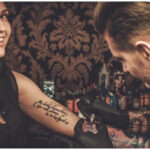 Tattoo artist applying numbing cream before tattoo