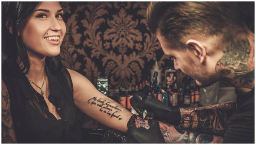 Tattoo artist applying numbing cream before tattoo