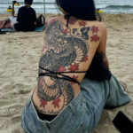 Back tattoo featuring intricate floral design, symbolizing beauty and growth