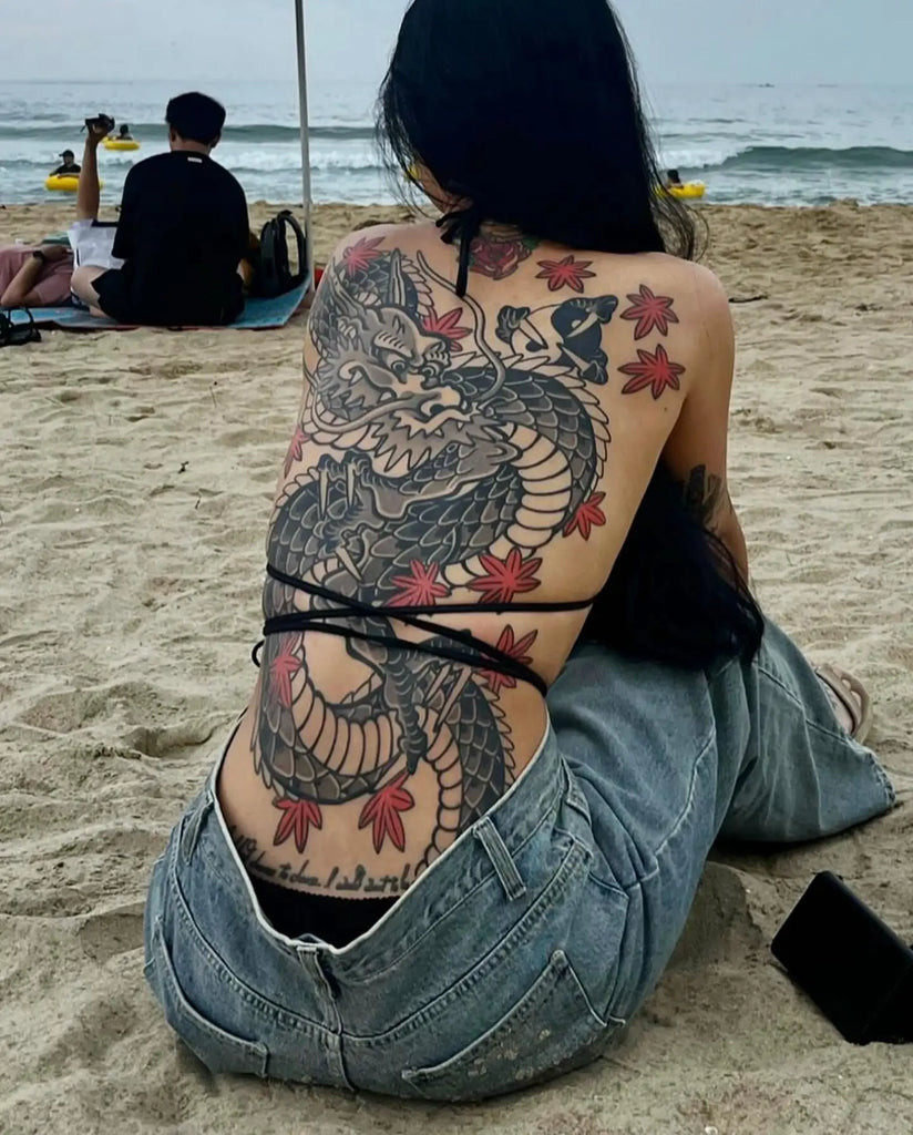 Back tattoo featuring intricate floral design, symbolizing beauty and growth