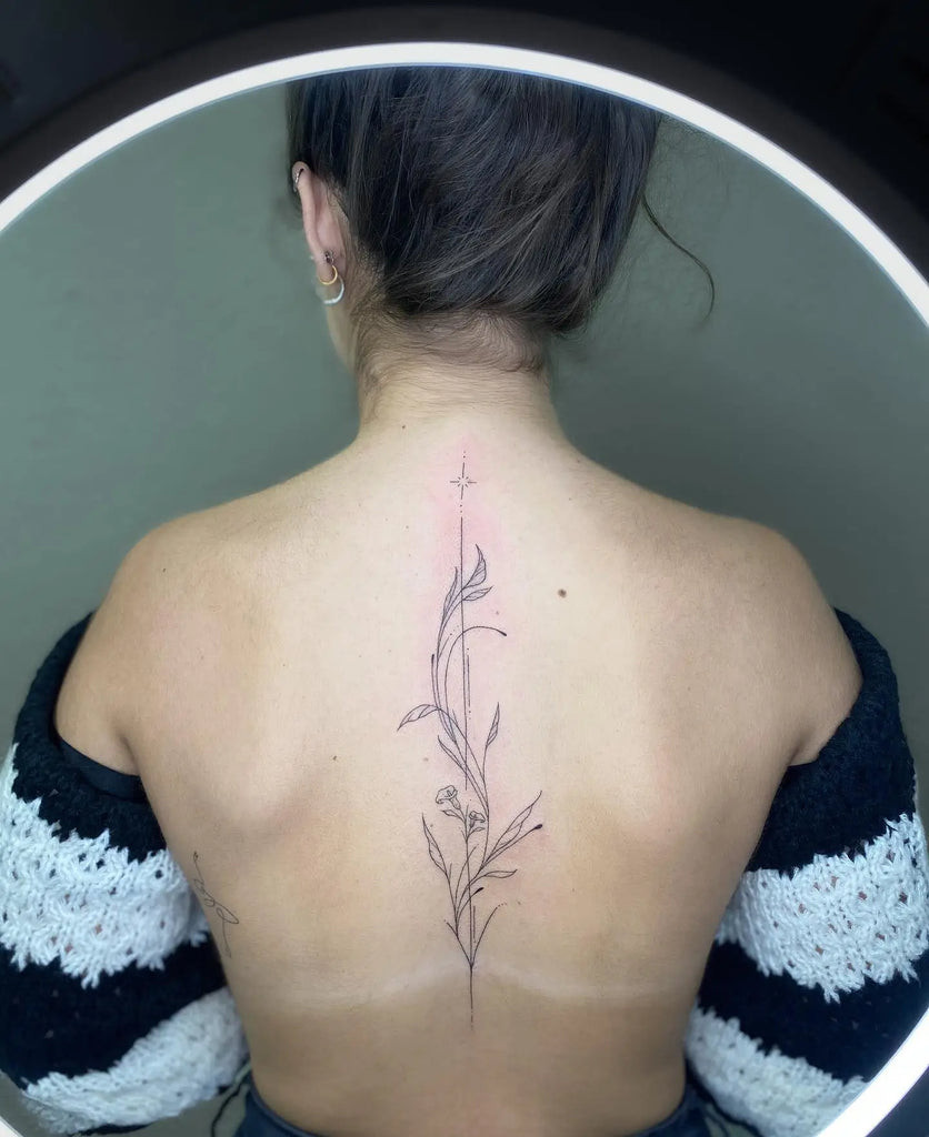 Back tattoo featuring symmetrical butterfly wings, symbolizing transformation and beauty