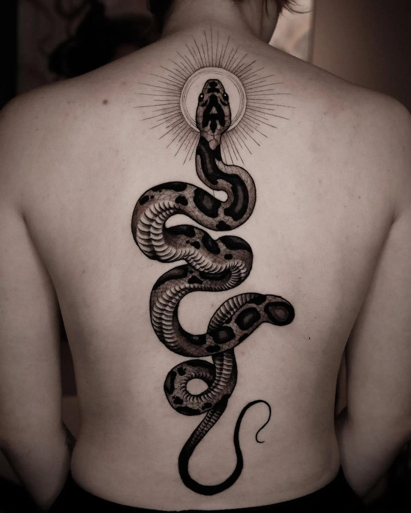 Back tattoo depicting a powerful lioness, embodying strength and courage