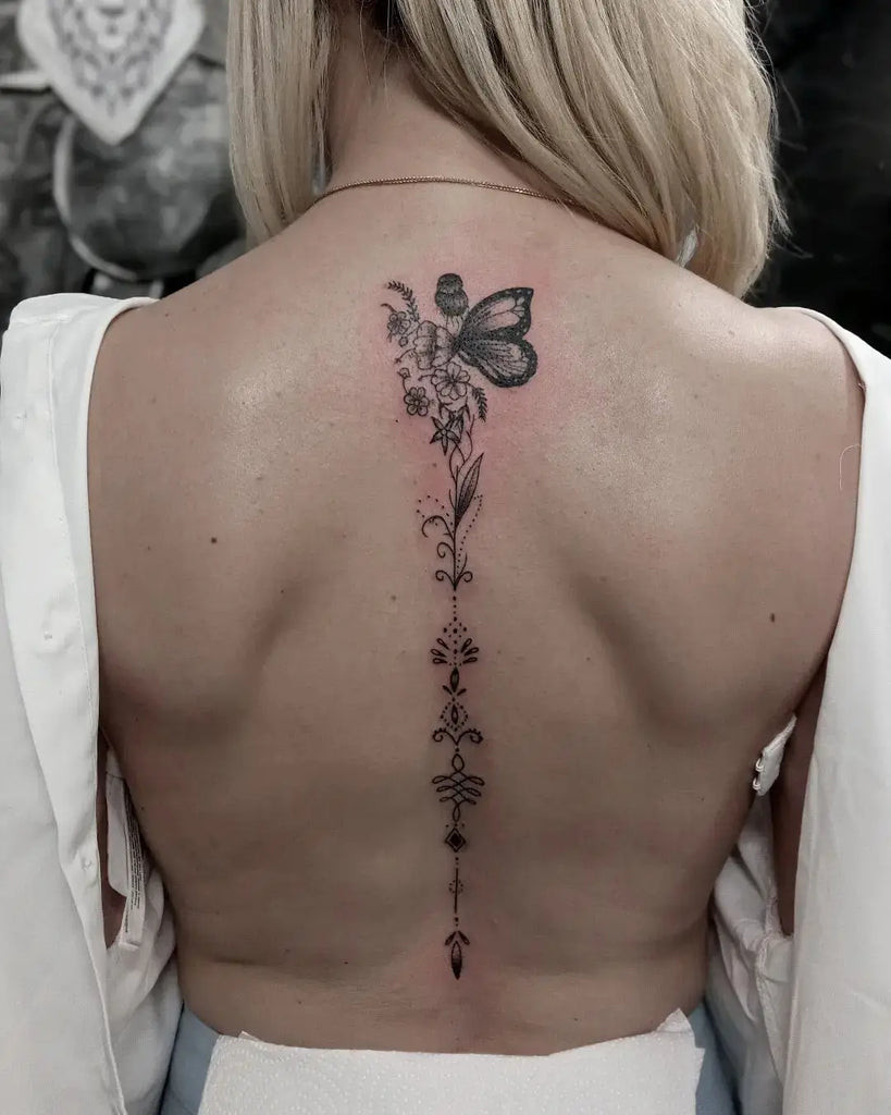 Back tattoo with watercolor effects, creating a soft and artistic look