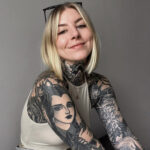 Close-up of a woman's forearm tattoo with light scabbing, showcasing the normal healing process