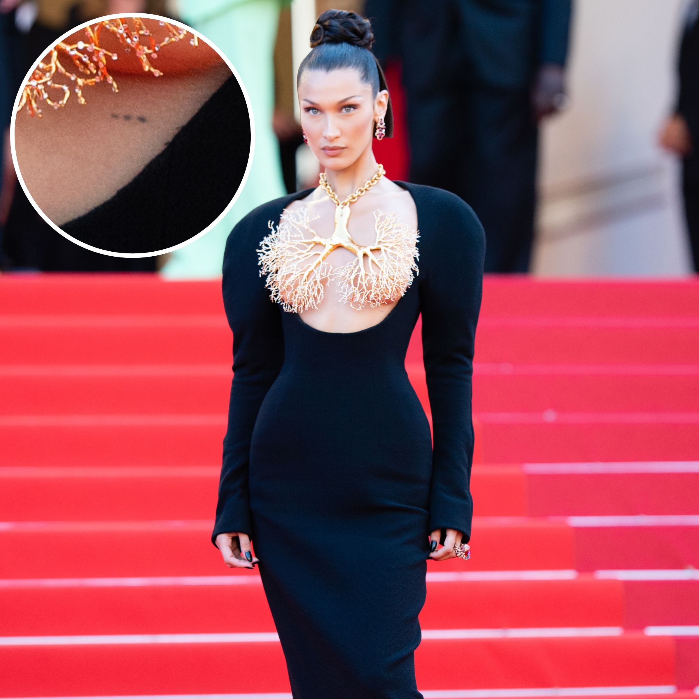 Bella Hadid showing three dots on her chest, a minimalist tattoo design gaining popularity