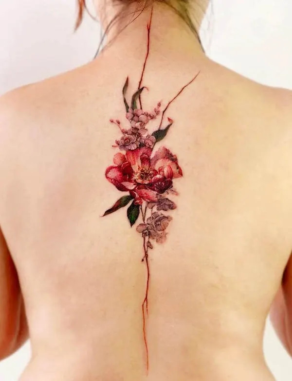 Beautiful spine tattoo featuring blooming flowers, created by @chou_ta_1