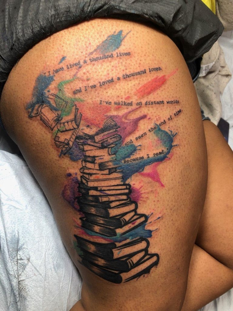 Book pile tattoo on arm