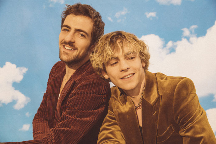 Ross Lynch with The Driver Era on tour. The photo catches Ross's energetic stage presence and connection with the audience, perfect for alt text linking celebrity, tattoo interest, and touring musician appeal.