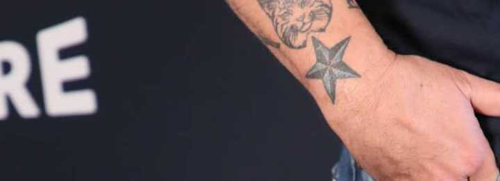 Close-up of Titus Welliver's blue and black star tattoo on his wrist