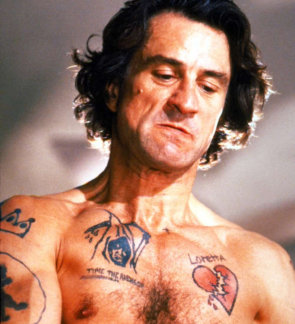 Robert De Niro as Max Cady in Cape Fear with prominent tattoos, showcasing the character's menacing persona and the impact of tattoos in cinematic storytelling.