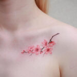 A stunning back piece featuring a vibrant Japanese cherry blossom tattoo with intricate details.