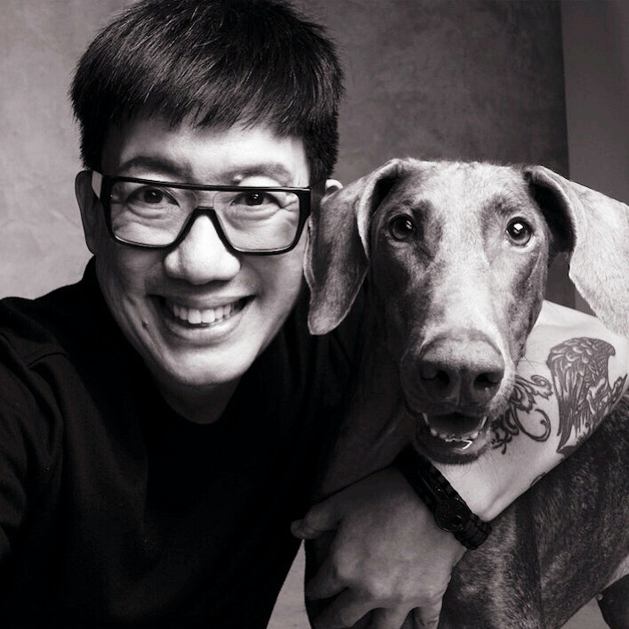 Man with tattoos and a dog