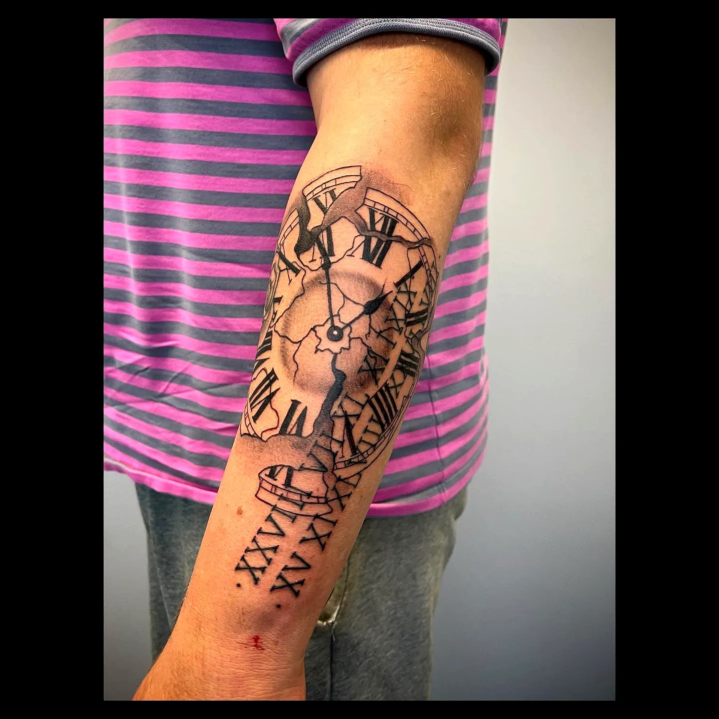 Detailed Broken Clock Forearm Tattoo with Cracked Roman Numerals