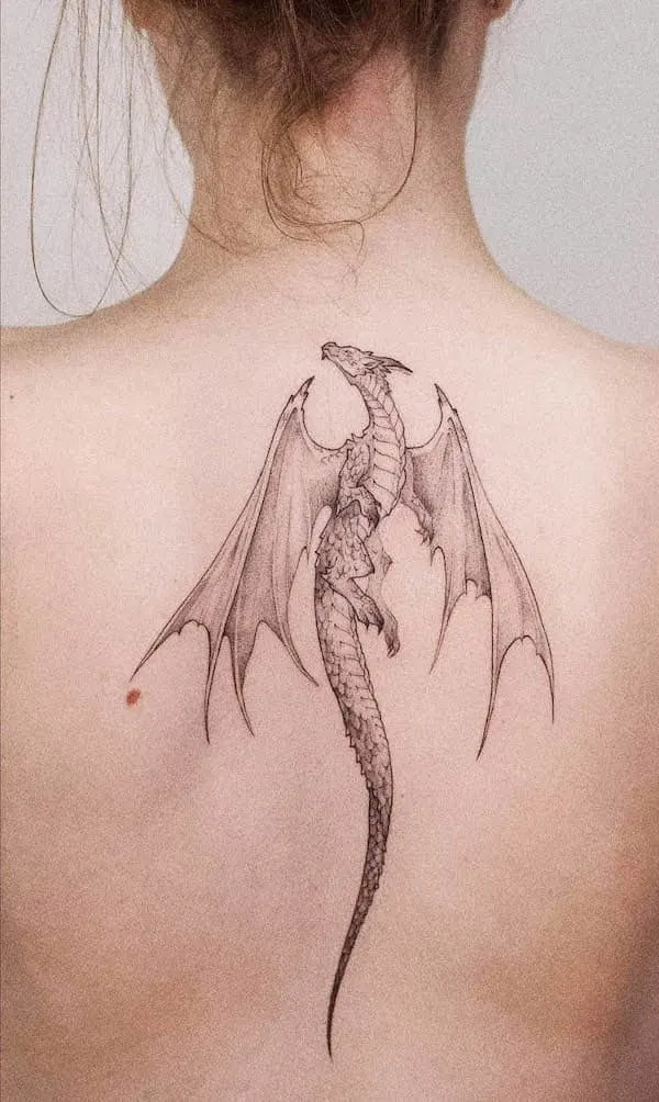 Intricate spine tattoo of a dragon, designed by @cami__ink