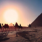 Travelers on camels before pyramids of Egypt as we discuss mosaic or ceremonial laws given to Israelite in the wilderness.