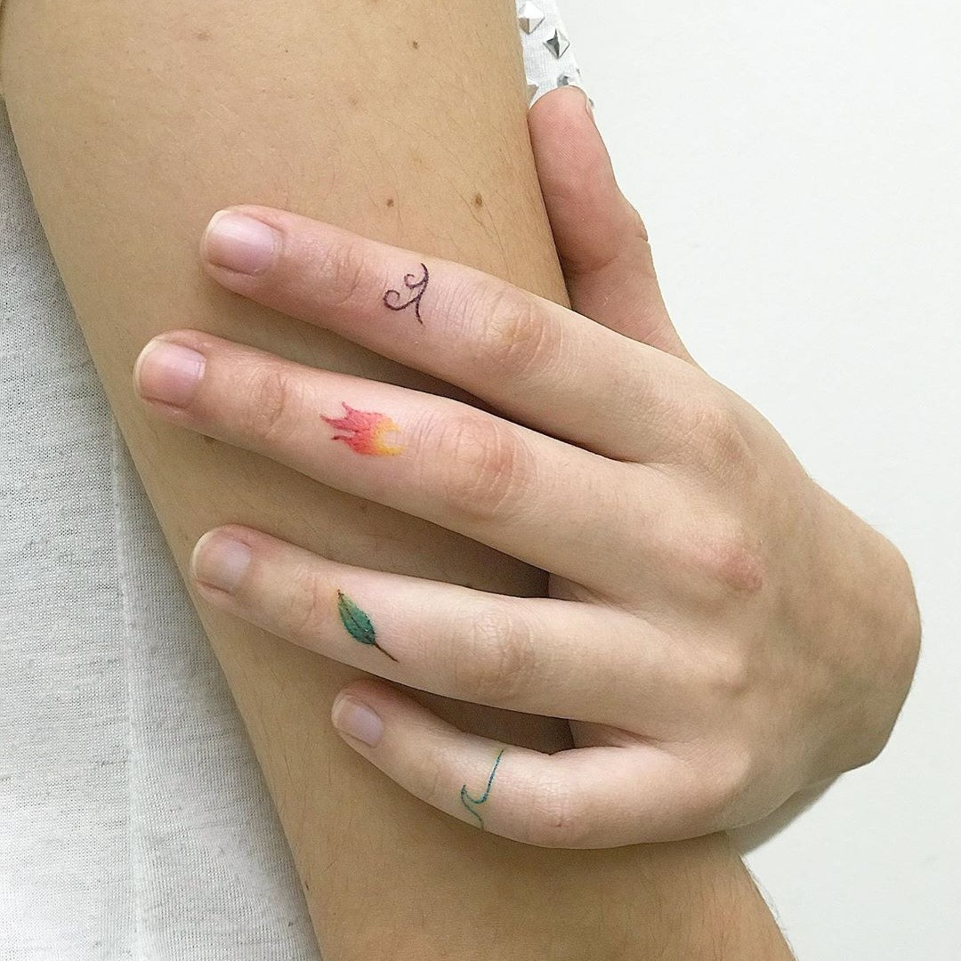 A finger tattoo symbolizing the fire element.