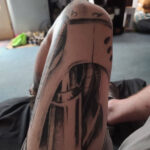 Mechanical thigh tattoo extends down the leg, showcasing intricate engineering designs for a futuristic look