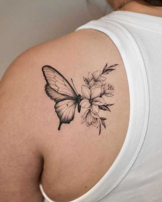 Elegant butterfly and flower ink design on the shoulder