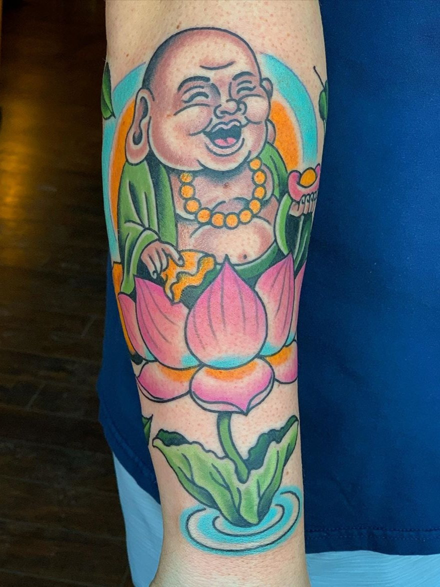 A colorful Buddha tattoo with a lotus flower