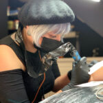 Close-up view of tattooing process, highlighting the needle and ink interaction with the skin layers