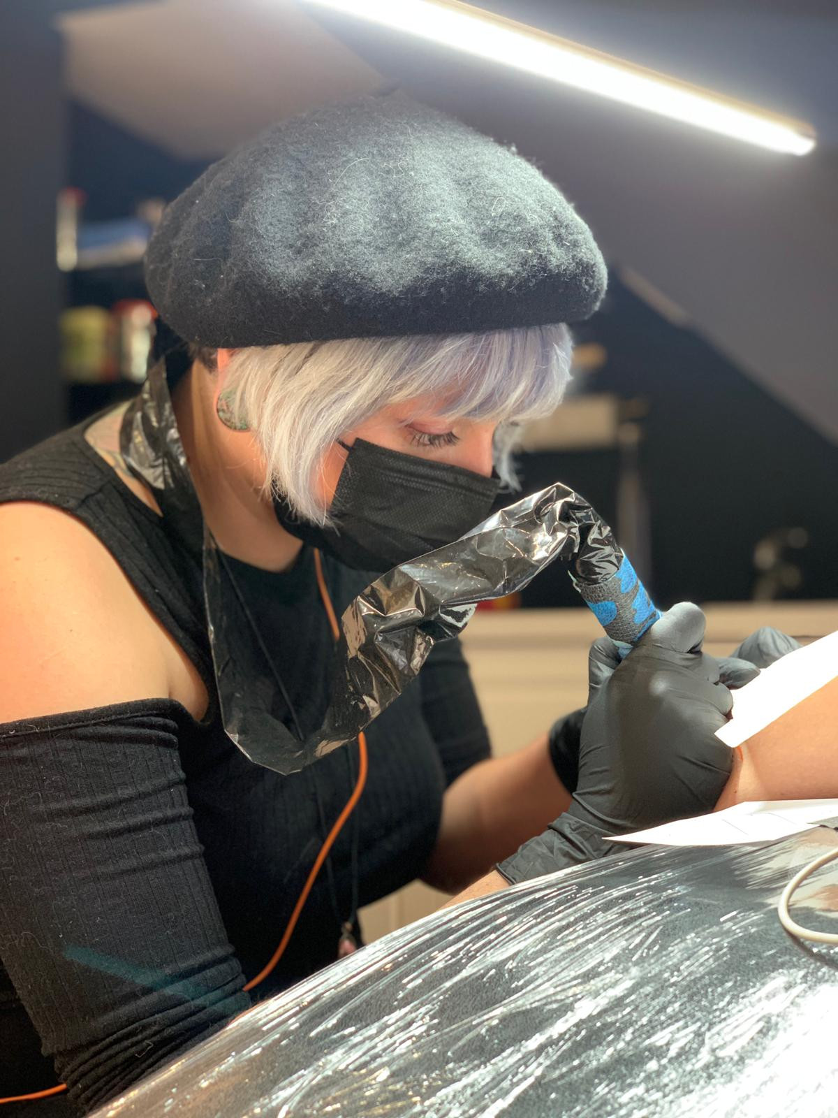 Close-up view of tattooing process, highlighting the needle and ink interaction with the skin layers