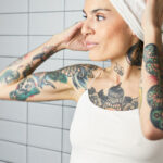 Woman using exfoliating body wash in the shower