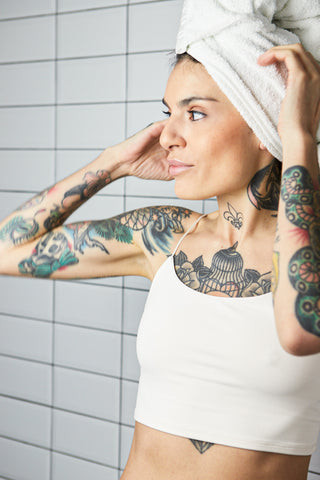 Woman using exfoliating body wash in the shower