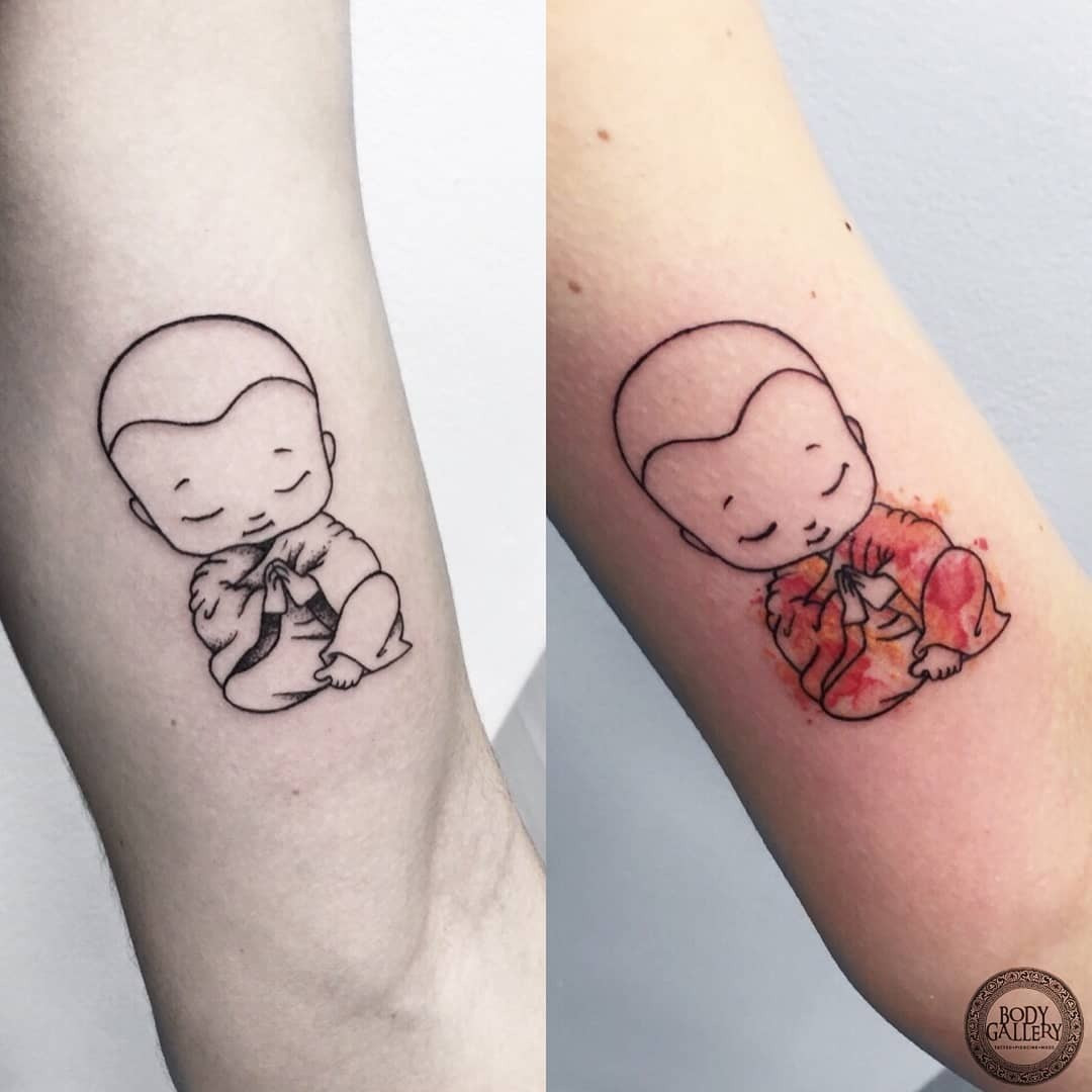 A small and simple Buddha tattoo with watercolor effect