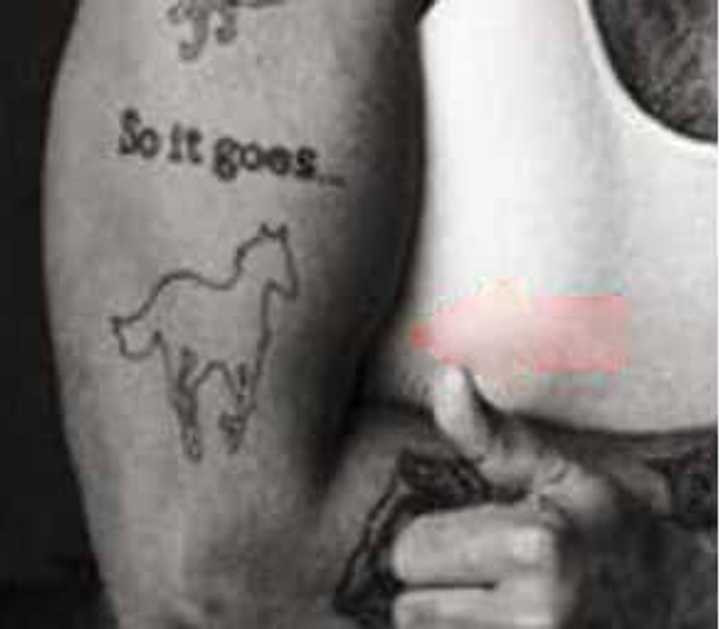 Titus Welliver displaying his White Pony tattoo with 'So it goes' inscription
