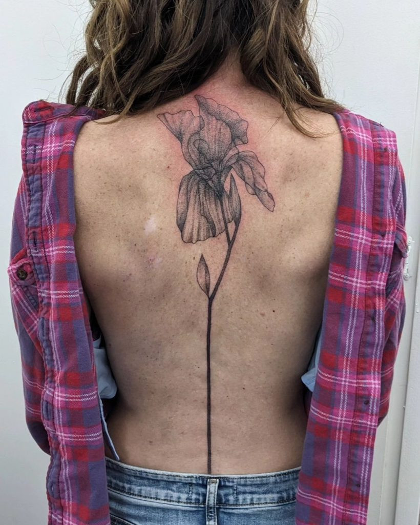 A captivating back piece tattoo featuring a blend of geometric patterns and nature-inspired elements, highlighting the complexity and artistry involved
