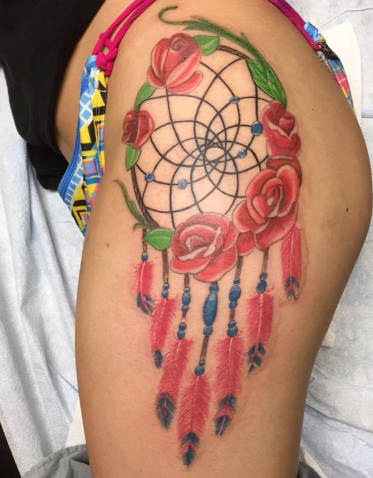 Native indian dreamcatcher tattoo with roses and leafs