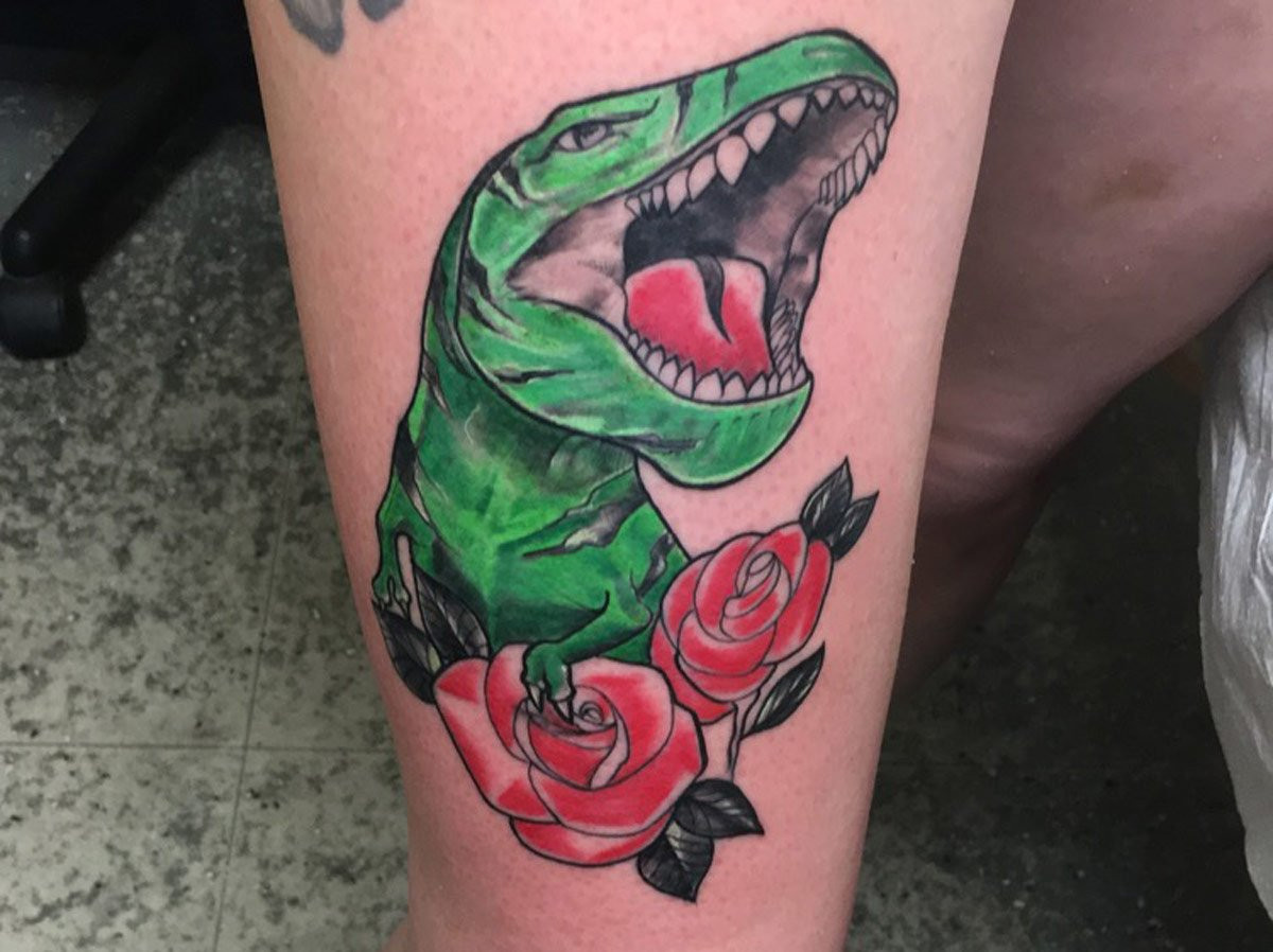 T-rex tattoo with roses - Artist: Breyner Alarcons