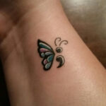 Semicolon tattoo on the inner wrist to symbolize mental health awareness