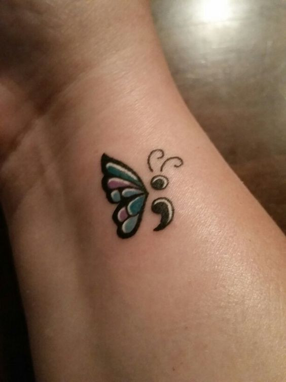 Semicolon tattoo on the inner wrist to symbolize mental health awareness