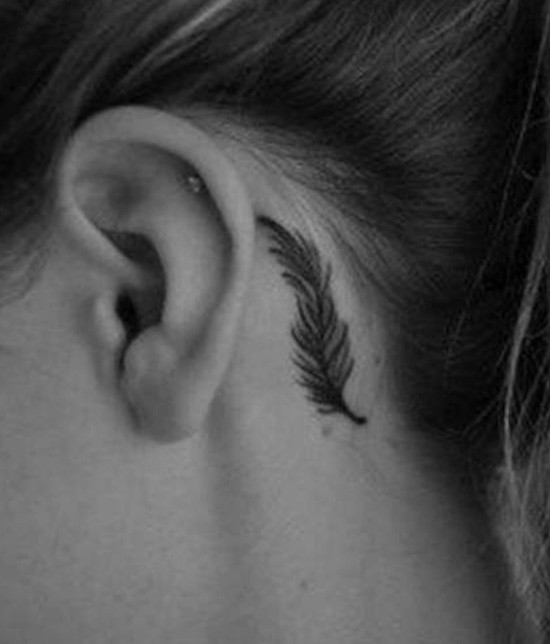 Feather tattoo behind the ear black ink