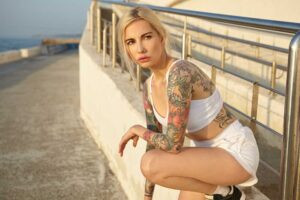 female in the sun with new color tattoos