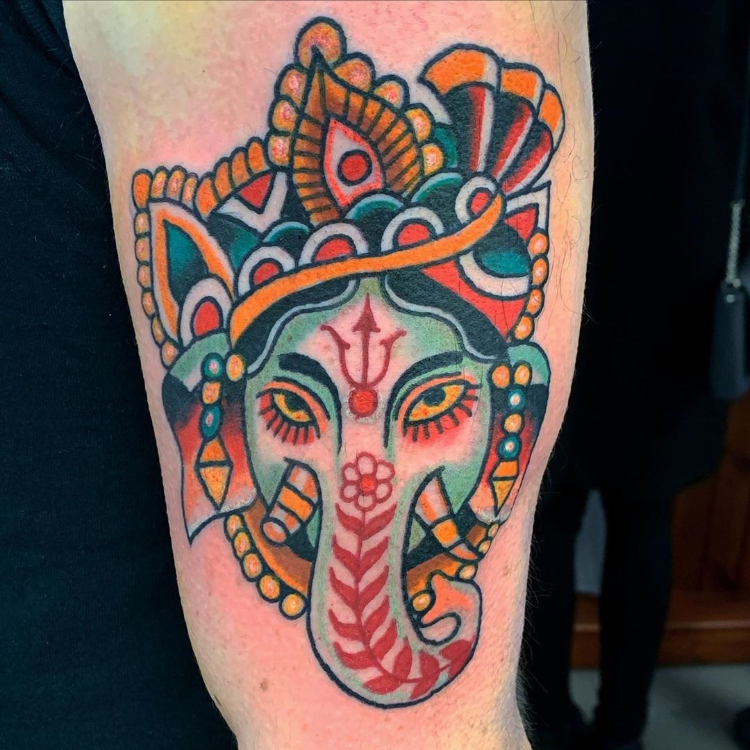 A Ganesha tattoo in vibrant colors