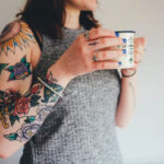 Teacher with flower tattoo on arm