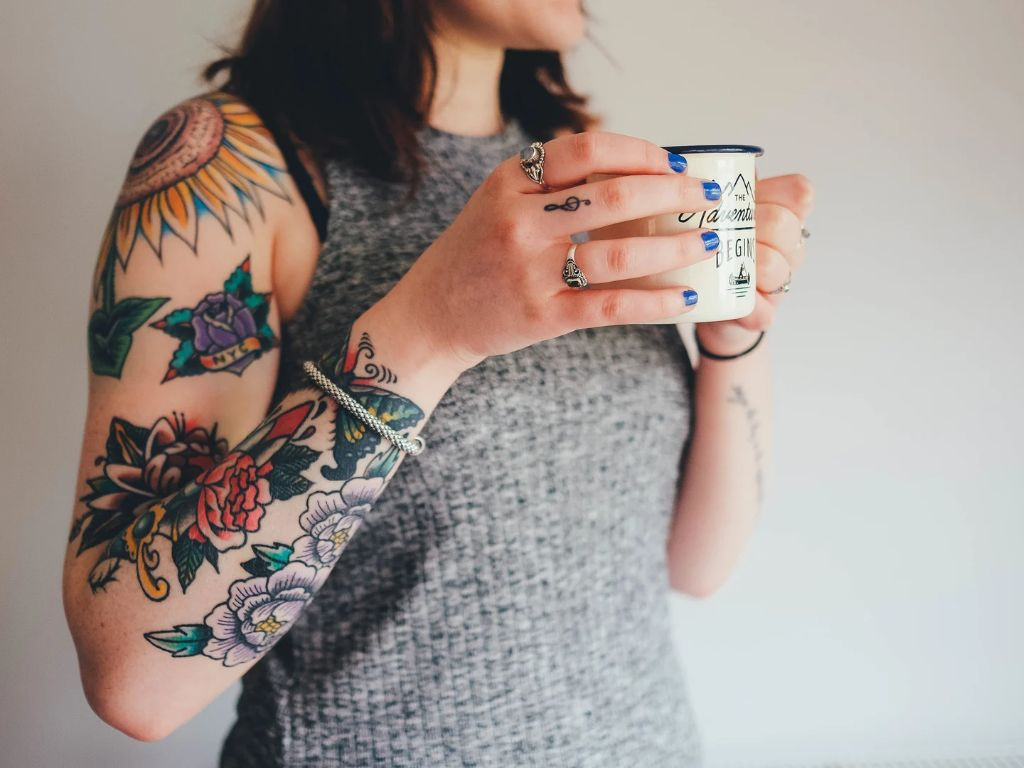Teacher with flower tattoo on arm