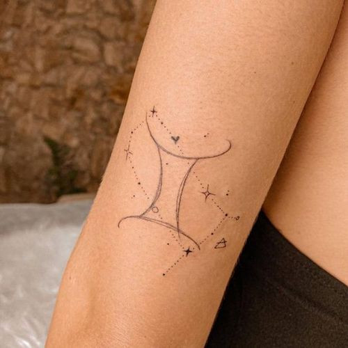 Small Gemini constellation tattoo on the back of the neck