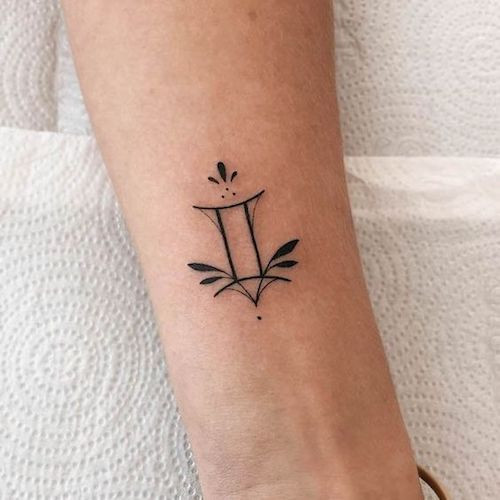 Minimalist black ink Gemini constellation tattoo on the forearm