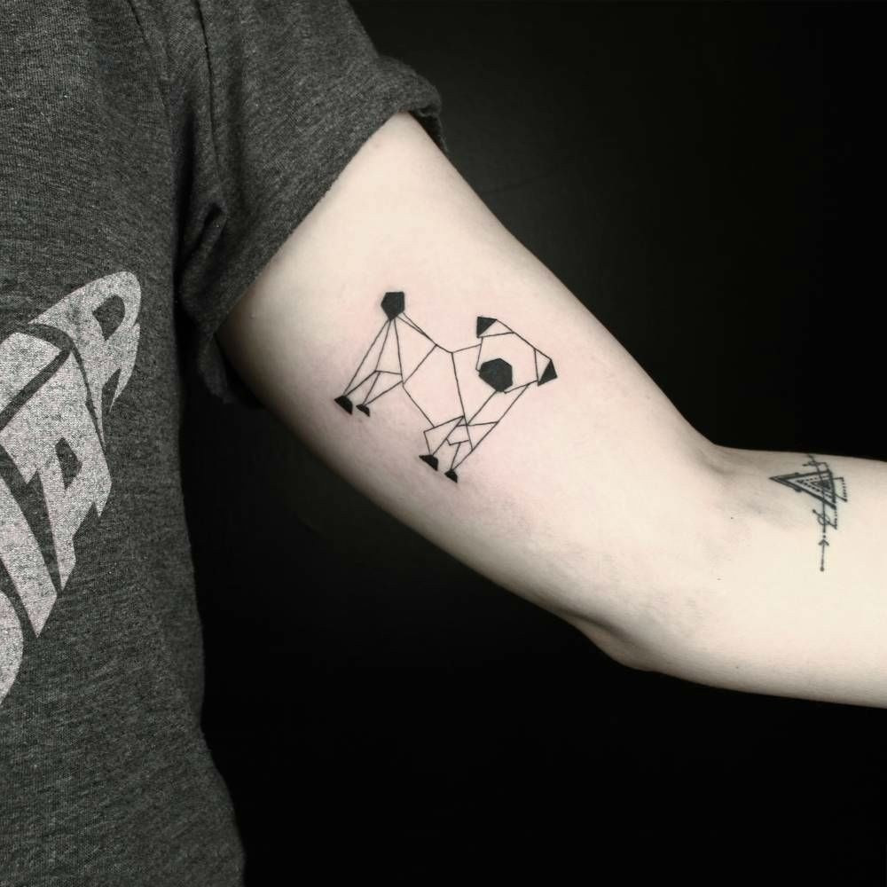 Geometric dog inner bicep tattoo for men with precise shapes