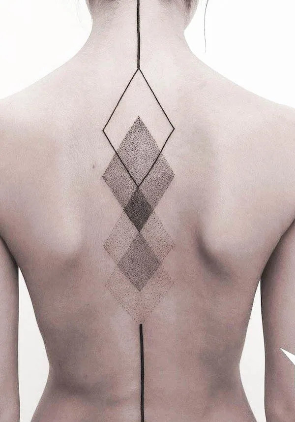 Eye-catching spine tattoo with a geometric design, created by @axelejsmont