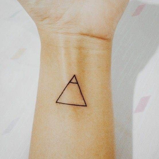 Glyph tattoos on the forearm symbolizing exploration and personal growth