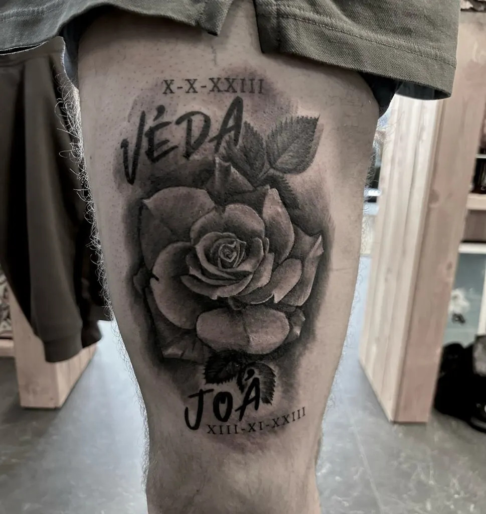 Realistic rose tattoo with names and dates, combining beauty and personal touch, creating a timeless and classic tribute