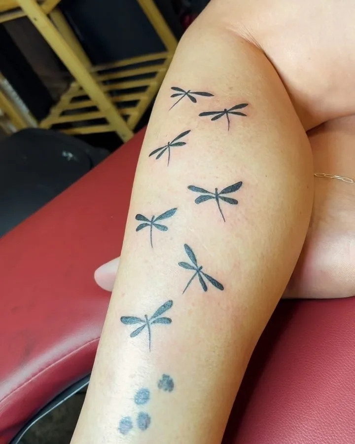 Dragonflies for grandchildren tattoo, symbolizing transformation and grace with a minimalist design representing the bond between grandparent and each grandchild