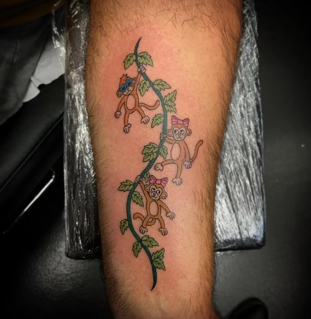 Monkey vine tattoo, depicting playful monkeys climbing a vine, symbolizing growth, adventure, and the unique personalities of loved ones