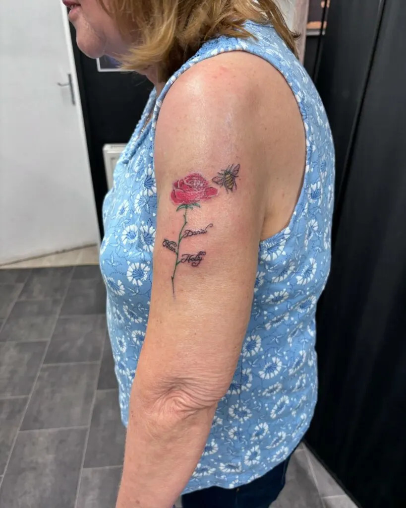 Rose with grandchildren's names and bee tattoo, symbolizing love and admiration with a beautiful rose, elegant names, and a touch of nature